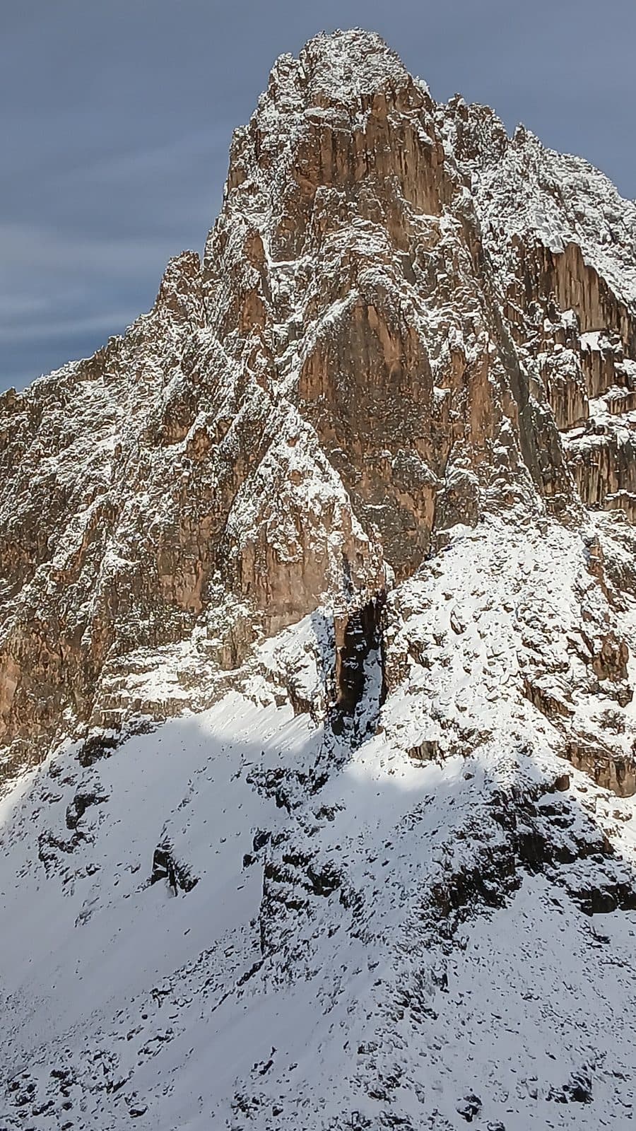 Snow-streaked rock face of Mount Kenya's main peak