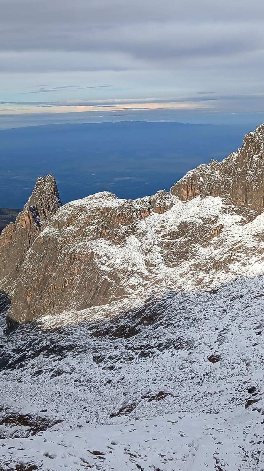 Snowy ridges falling away to the plains far below Mount Kenya